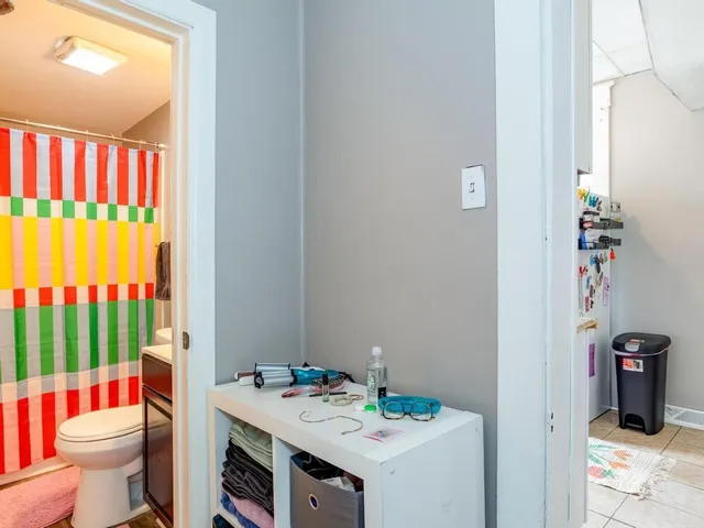a bathroom with a sink toilet and window