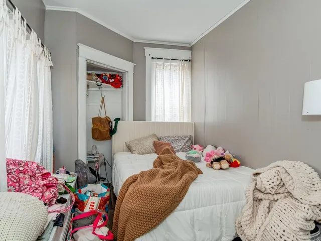 a bedroom with a bed and a window