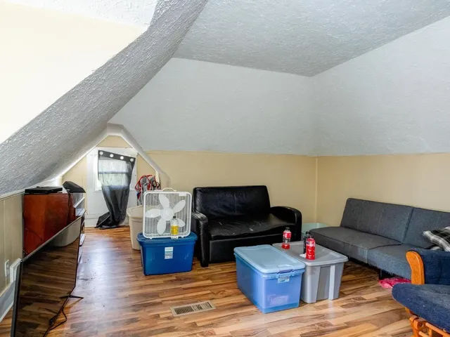 a living room with furniture and a lamp