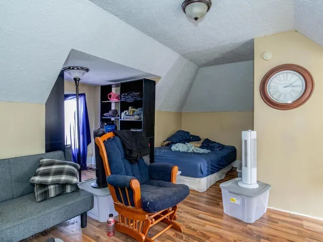a living room with furniture and a gym machine
