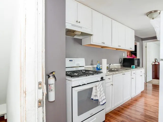a kitchen with white cabinets and white appliances