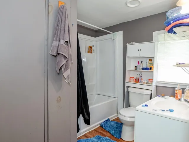 a bathroom with a sink toilet vanity and shower