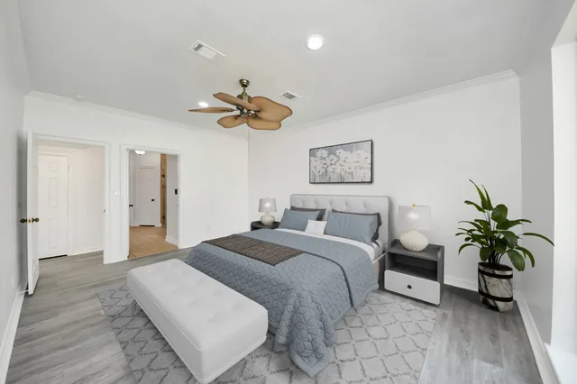 a bedroom with a bed and a chandelier