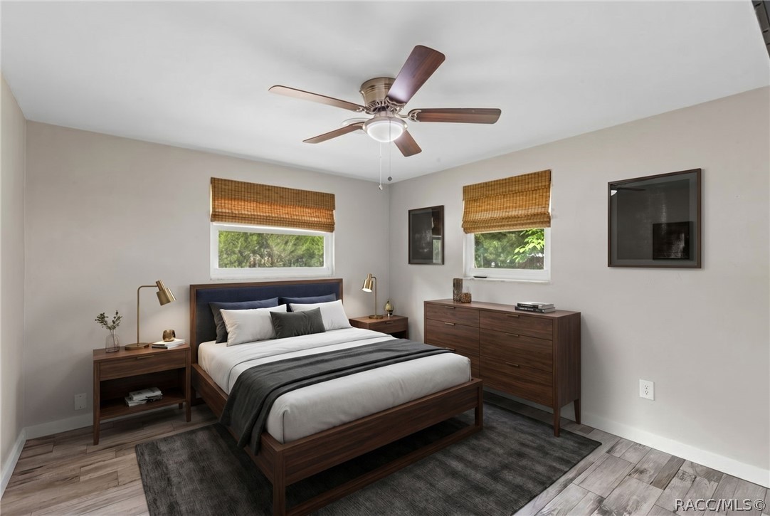 107 Allen Avenue Inglis, FL 34449 - Photo 15 of 36 a bedroom with a bed and a chandelier