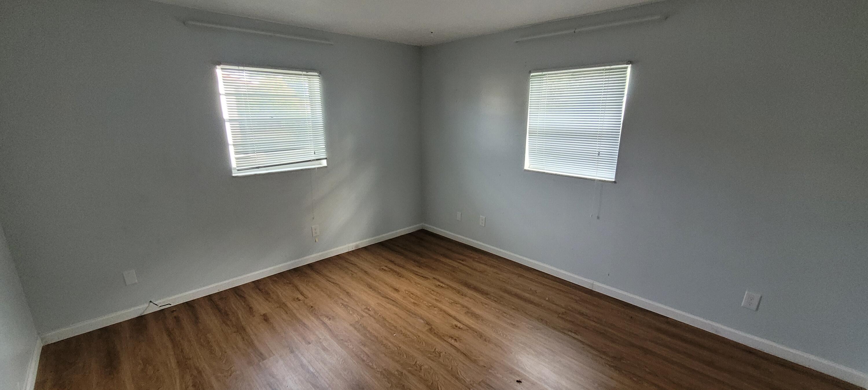 351 West 21st Street Riviera Beach, FL 33404 - Photo 11 of 11 an empty room with wooden floor and windows