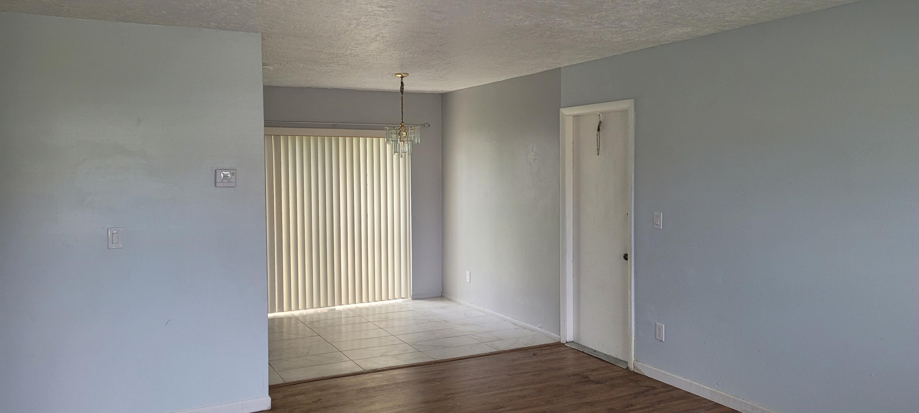 351 West 21st Street Riviera Beach, FL 33404 - Photo 3 of 11 an empty room with closet and wooden floor