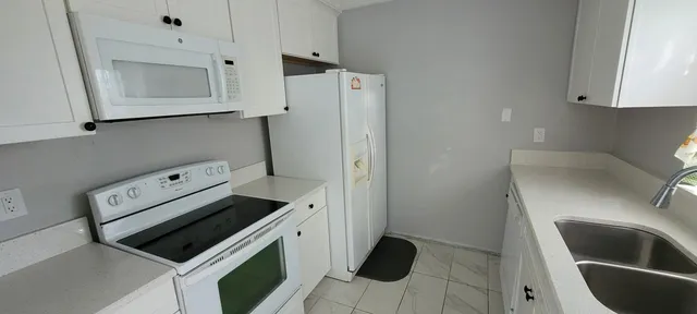 a kitchen with stainless steel appliances a stove a microwave and a refrigerator