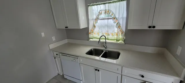 a kitchen with a sink and cabinets