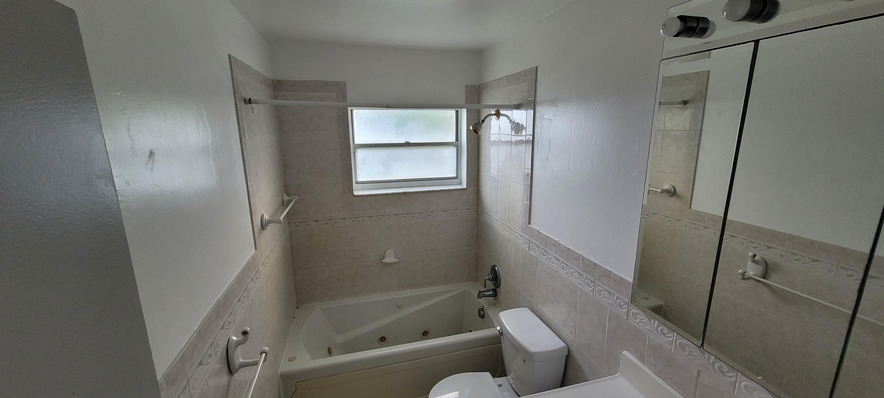 351 West 21st Street Riviera Beach, FL 33404 - Photo 7 of 11 a bathroom with a tub and a shower