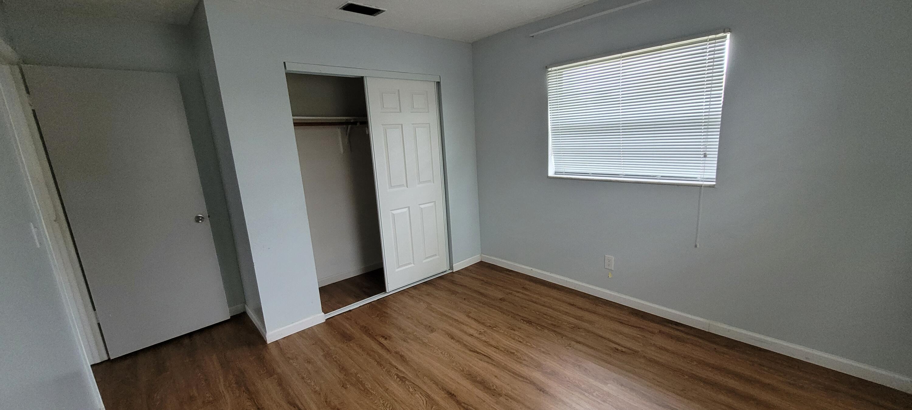 351 West 21st Street Riviera Beach, FL 33404 - Photo 10 of 11 an empty room with wooden floor closet and windows
