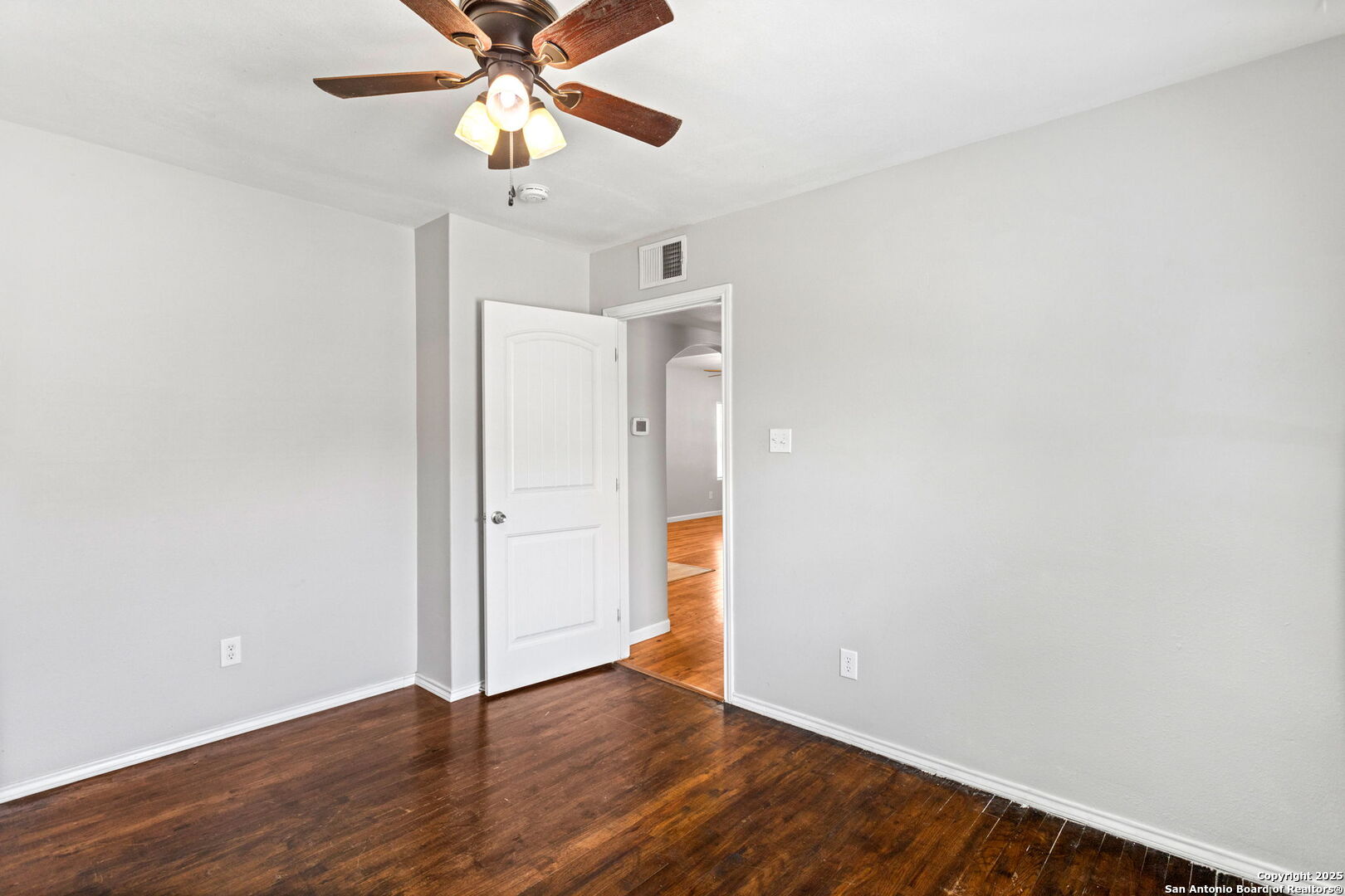 1336 West Ridgewood Court, Unit 1 San Antonio, TX 78201 - Photo 12 of 15 a view of an empty room with window and wooden floor