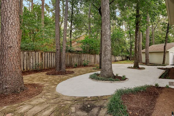 a wooden bench sitting in the middle of a yard