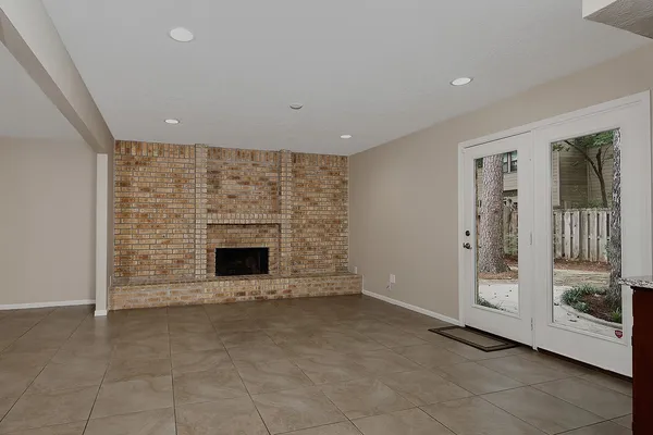 a view of an empty room with a fireplace