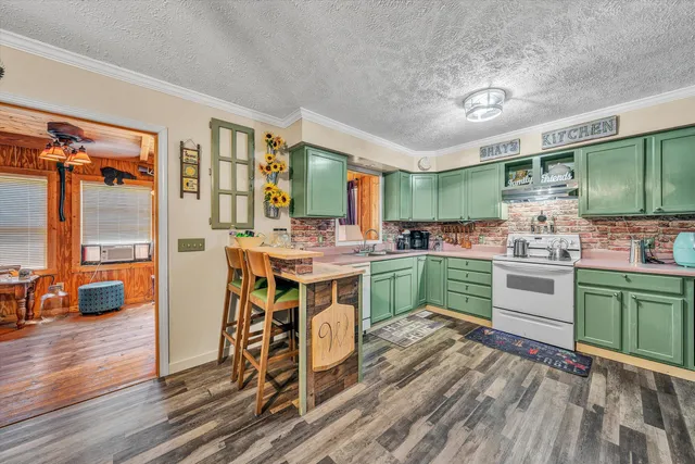 a kitchen with a sink cabinets and wooden floor
