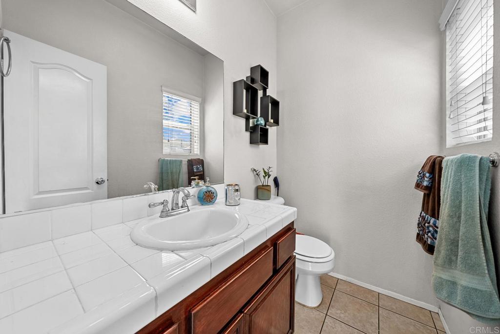 832 Laffey Lane El Cajon, CA 92021 - Photo 23 of 47 a bathroom with a sink toilet and mirror