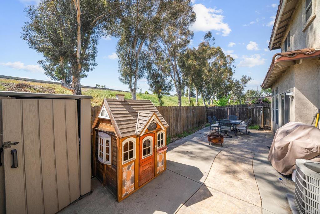 832 Laffey Lane El Cajon, CA 92021 - Photo 28 of 47 a view of a chair and table in the back yard of the house
