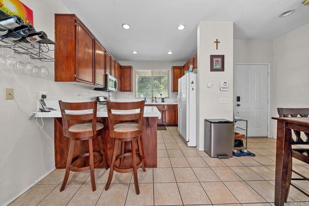 832 Laffey Lane El Cajon, CA 92021 - Photo 3 of 47 a kitchen with stainless steel appliances kitchen island granite countertop a refrigerator and a stove top oven