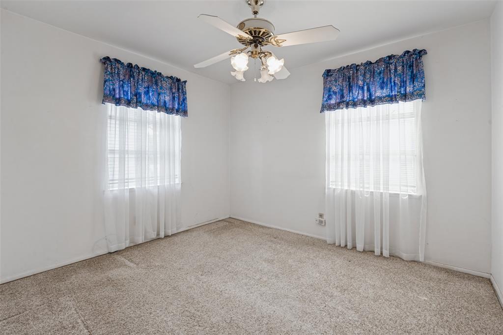 2528 Rugby Lane Farmers Branch, TX 75234 - Photo 6 of 12 Recessed windows with blinds, wall-to-wall carpeting, and a ceiling fan with light fixture