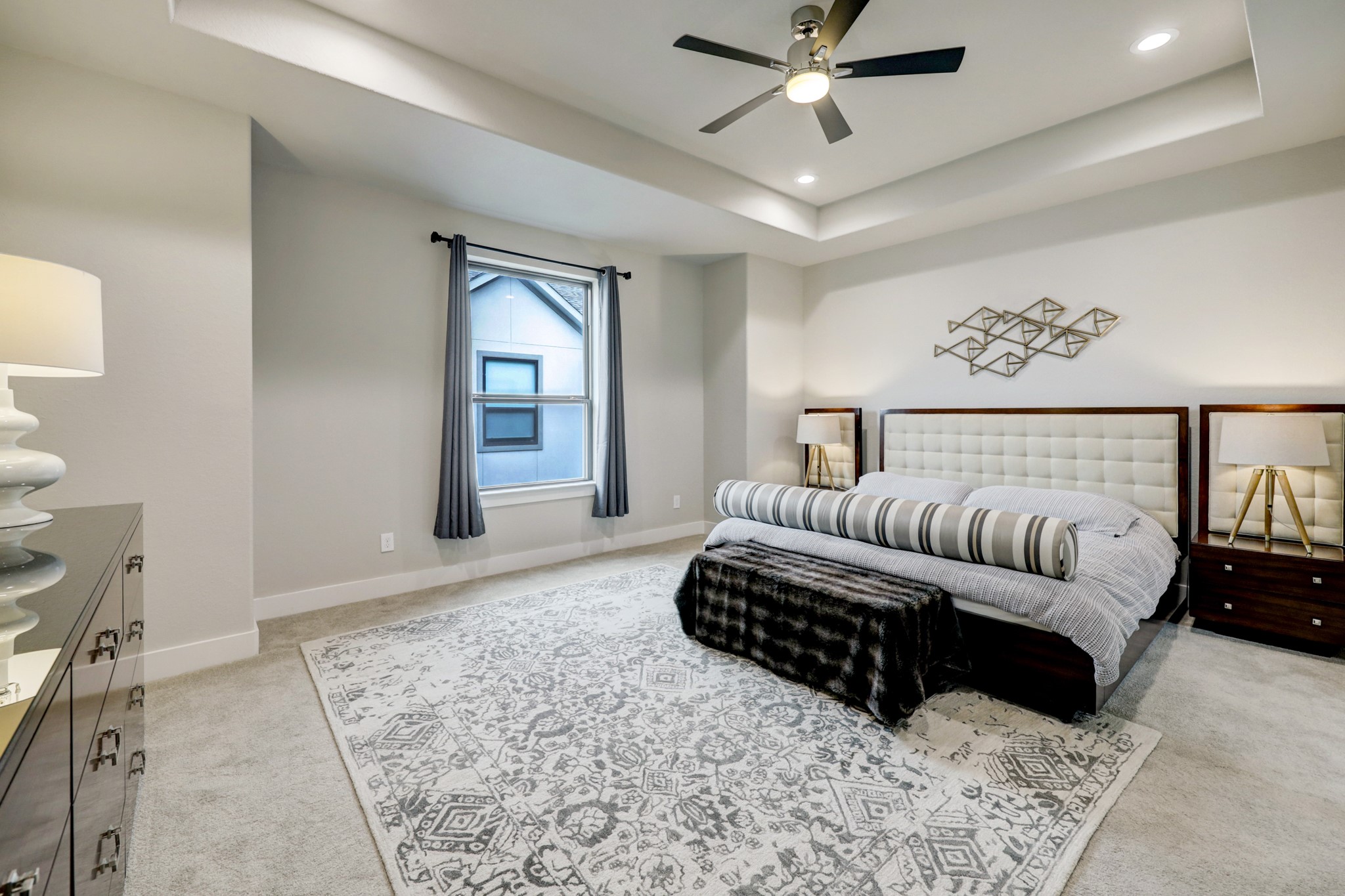 4203 Allen Street Houston, TX 77007 - Photo 23 of 35 a spacious bedroom with a bed a couch and ceiling fan