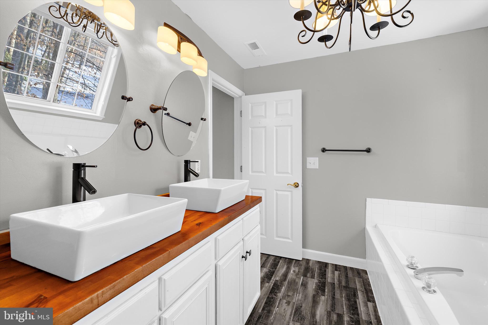 7144 Fir Street Easton, MD 21601 - Photo 16 of 24 a bathroom with a sink and a mirror
