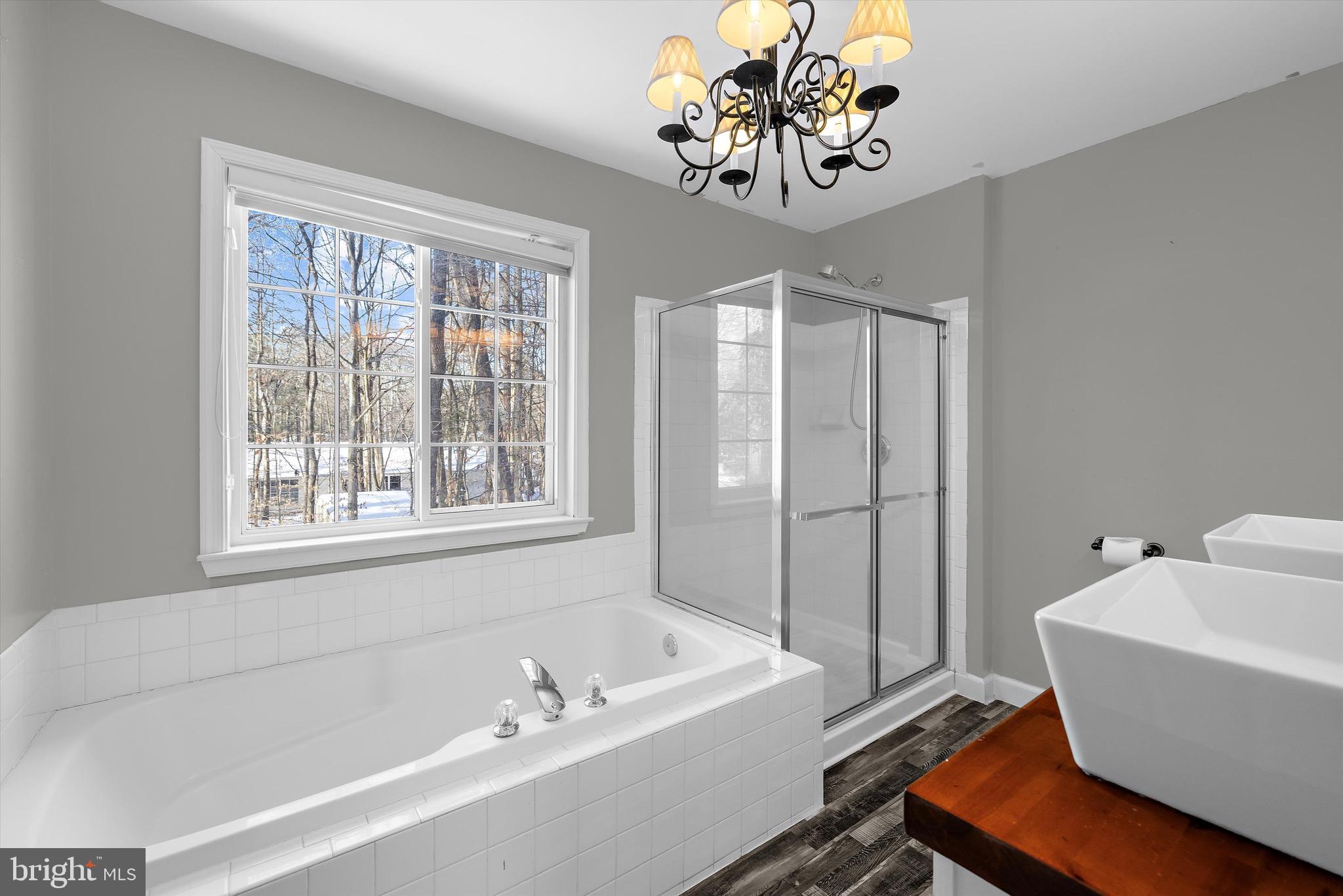 7144 Fir Street Easton, MD 21601 - Photo 17 of 24 a bath room with a bathtub and a shower