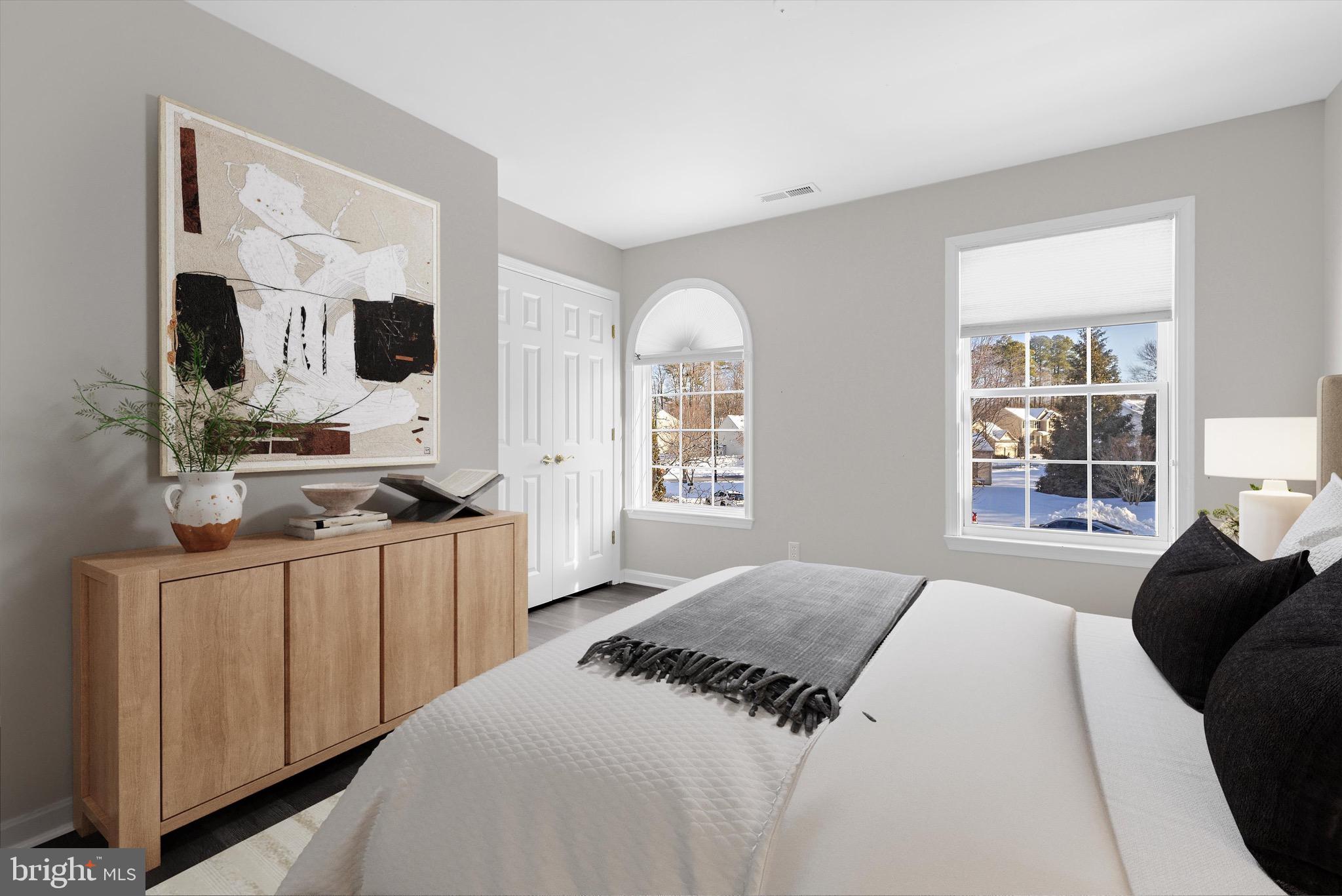 7144 Fir Street Easton, MD 21601 - Photo 19 of 24 a bedroom with a bed a flat tv screen and a dresser