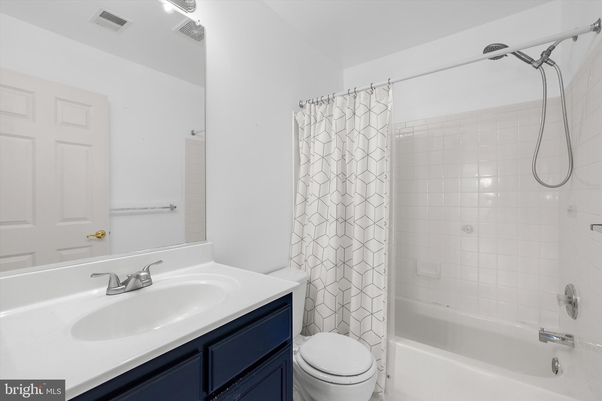 7144 Fir Street Easton, MD 21601 - Photo 20 of 24 a bathroom with a sink a toilet and shower