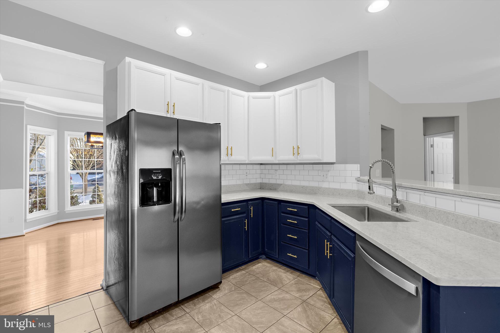 7144 Fir Street Easton, MD 21601 - Photo 5 of 24 a kitchen with stainless steel appliances granite countertop a refrigerator and a sink