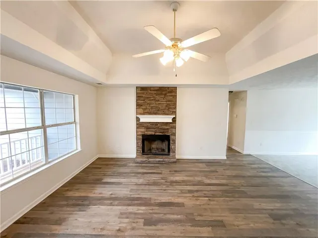 a view of an empty room with a fireplace and a window
