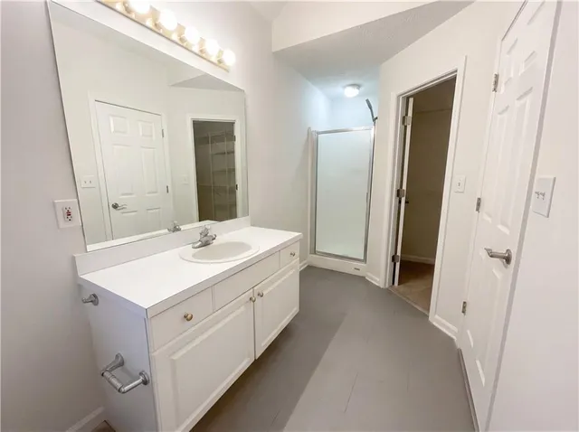 a bathroom with a sink a mirror and a shower