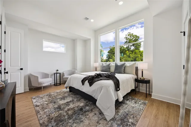 a bed room with a bed and a chair