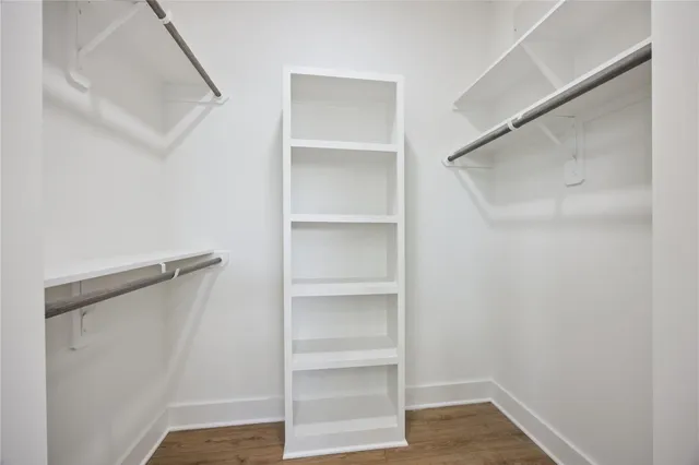 a view of walk in closet with empty racks