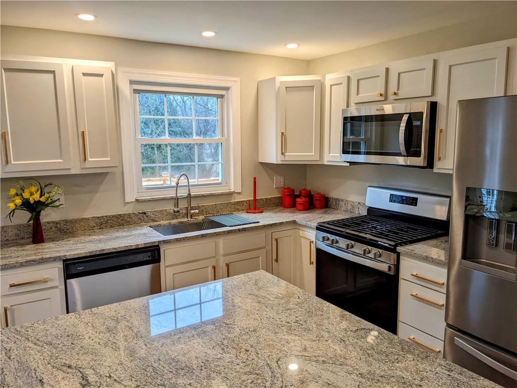 432 Raspberry Drive Monroeville, PA 15146 - Photo 12 of 39 a kitchen with stainless steel appliances granite countertop a sink stove and refrigerator