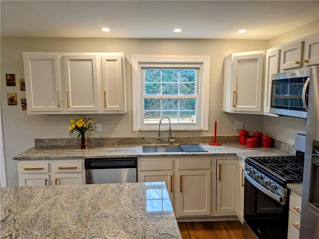432 Raspberry Drive Monroeville, PA 15146 - Photo 13 of 39 a kitchen with stainless steel appliances granite countertop a stove a sink and a microwave