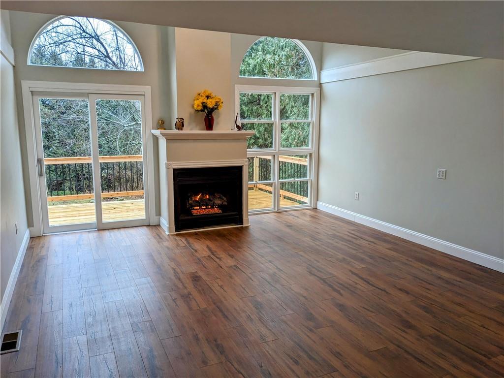 432 Raspberry Drive Monroeville, PA 15146 - Photo 15 of 39 an empty room with wooden floor a fireplace and windows