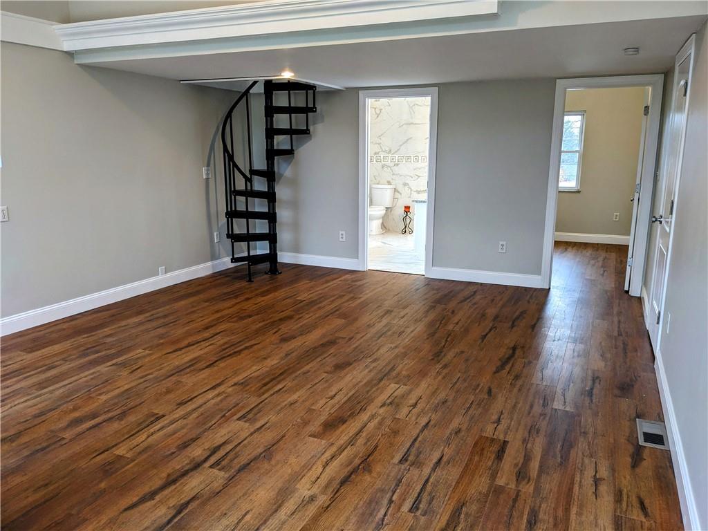 432 Raspberry Drive Monroeville, PA 15146 - Photo 17 of 39 a view of an empty room with wooden floor window and staircase
