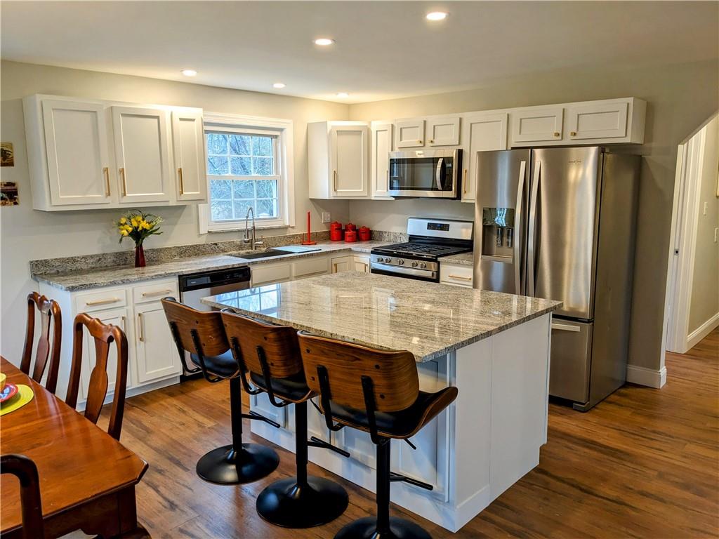 432 Raspberry Drive Monroeville, PA 15146 - Photo 10 of 39 a kitchen with stainless steel appliances granite countertop a table chairs sink refrigerator and microwave