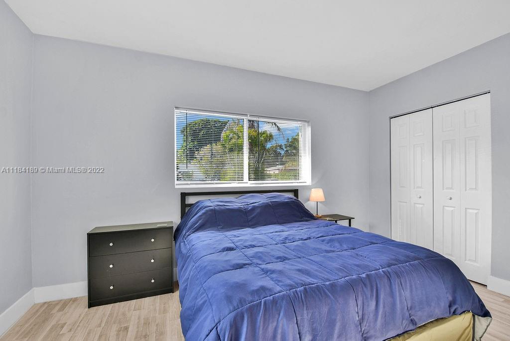 331 Northwest 144th Street Miami, FL 33168 - Photo 13 of 35 a bedroom with a bed and window