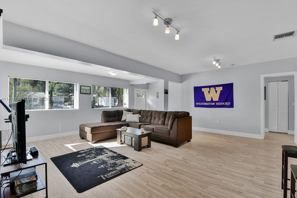331 Northwest 144th Street Miami, FL 33168 - Photo 15 of 35 a living room with furniture and a flat screen tv