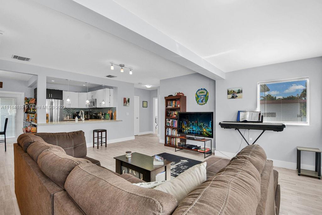 331 Northwest 144th Street Miami, FL 33168 - Photo 18 of 35 a living room with furniture and a flat screen tv