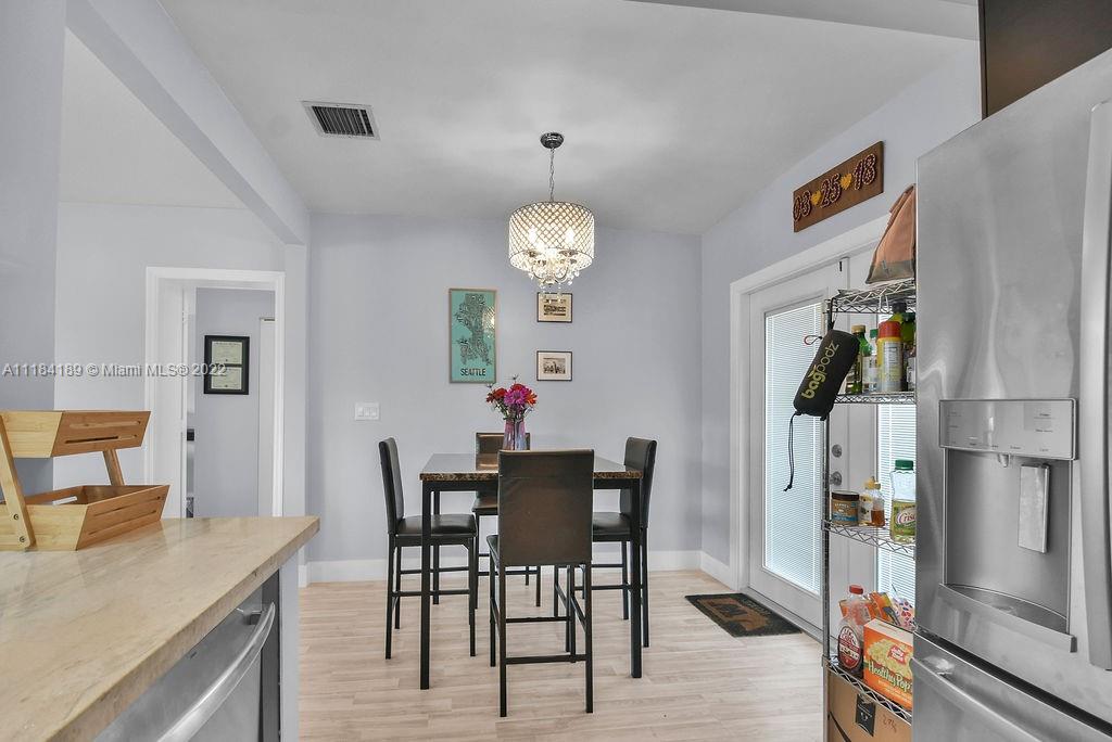 331 Northwest 144th Street Miami, FL 33168 - Photo 24 of 35 a view of a dining room with furniture and wooden floor