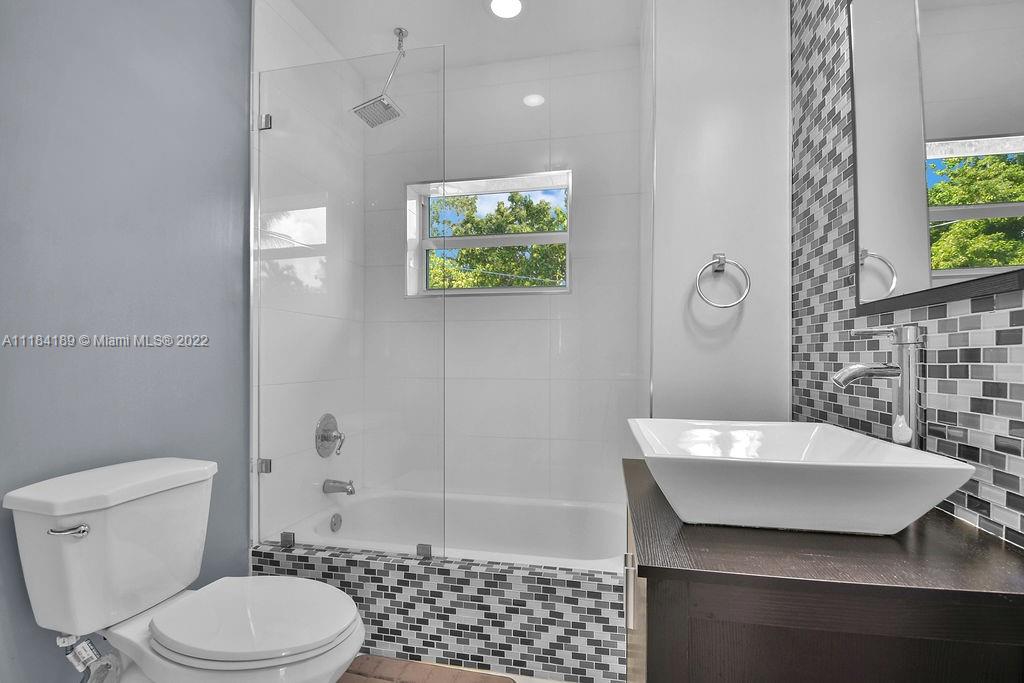 331 Northwest 144th Street Miami, FL 33168 - Photo 25 of 35 a bathroom with a sink toilet and shower