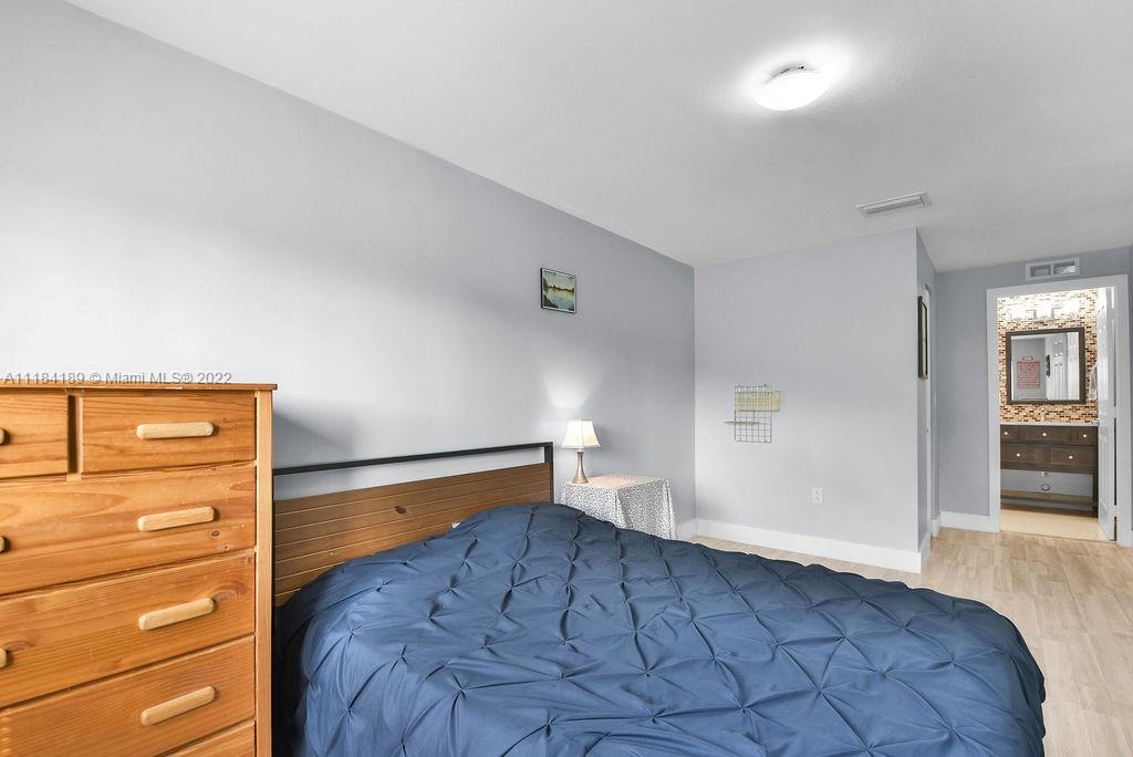 331 Northwest 144th Street Miami, FL 33168 - Photo 28 of 35 a bedroom with a bed and a view of closet