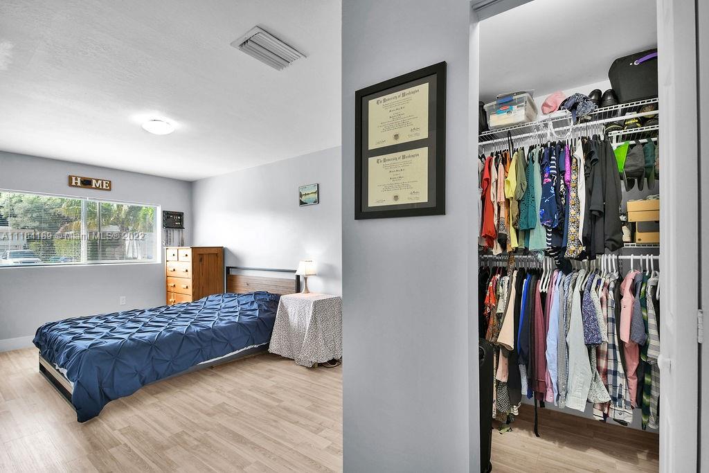 331 Northwest 144th Street Miami, FL 33168 - Photo 29 of 35 a living room with lots of clothes and shoes