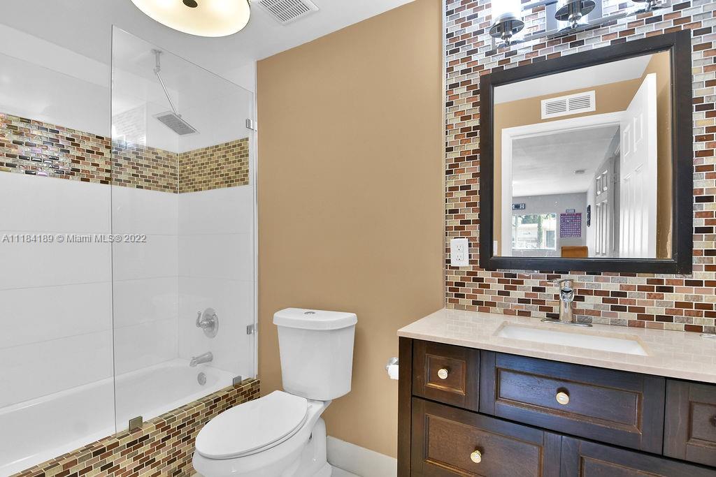 331 Northwest 144th Street Miami, FL 33168 - Photo 30 of 35 a bathroom with a sink a toilet and shower