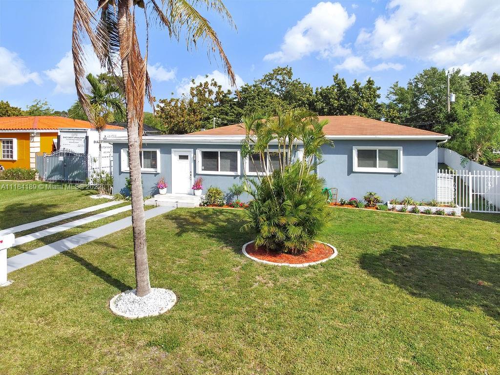 331 Northwest 144th Street Miami, FL 33168 - Photo 3 of 35 a front view of a house with a yard