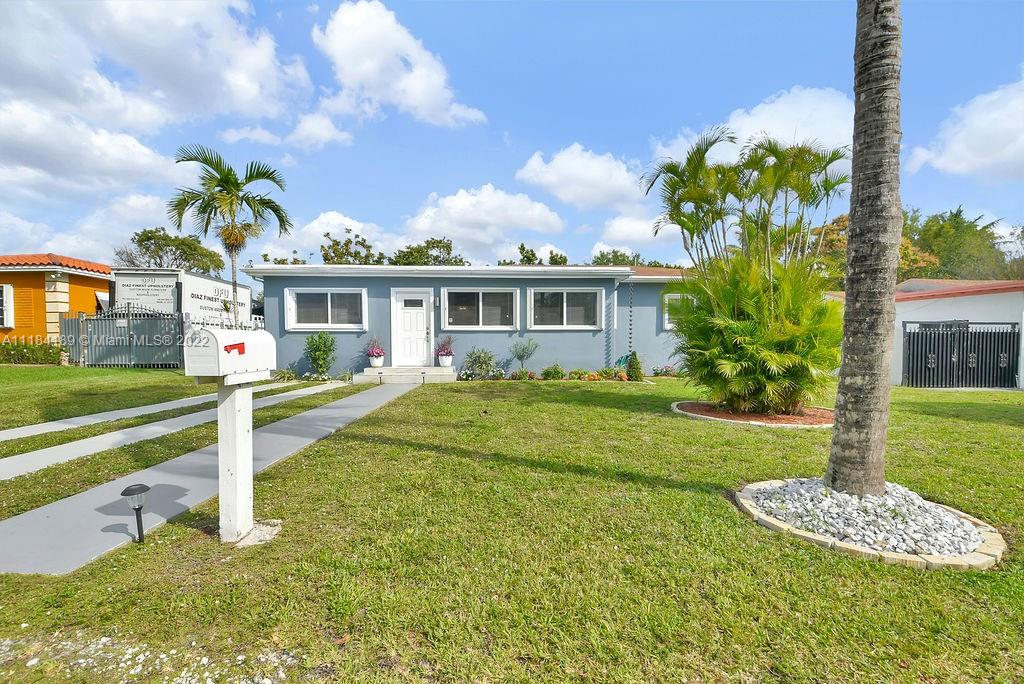 331 Northwest 144th Street Miami, FL 33168 - Photo 4 of 35 a front view of a house with a yard table and chairs