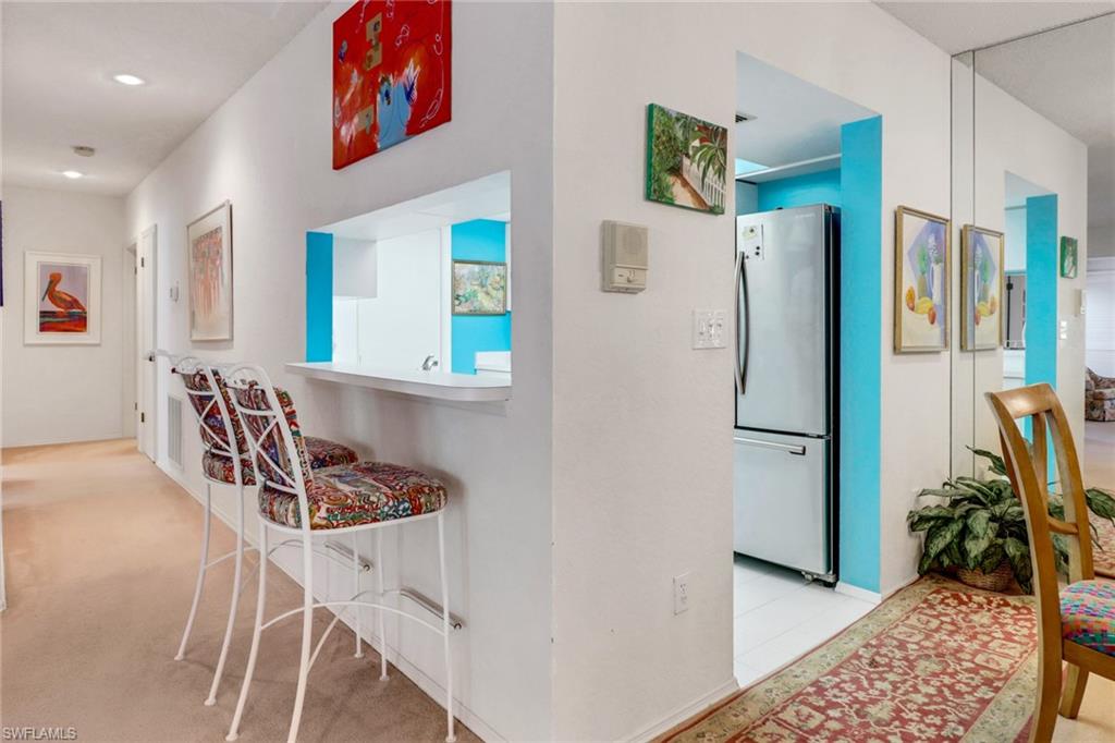 110 Siena Way, Unit 206 Naples, FL 34119 - Photo 11 of 35 a kitchen with stainless steel appliances granite countertop a refrigerator and a sink