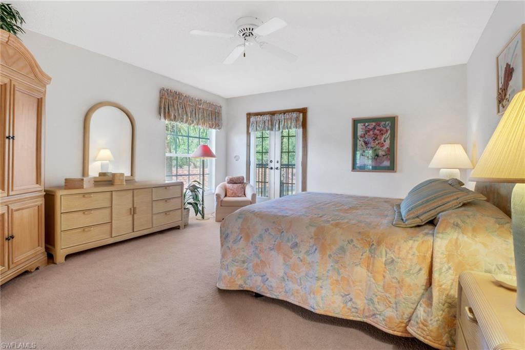 110 Siena Way, Unit 206 Naples, FL 34119 - Photo 17 of 35 a spacious bedroom with a bed and a large window