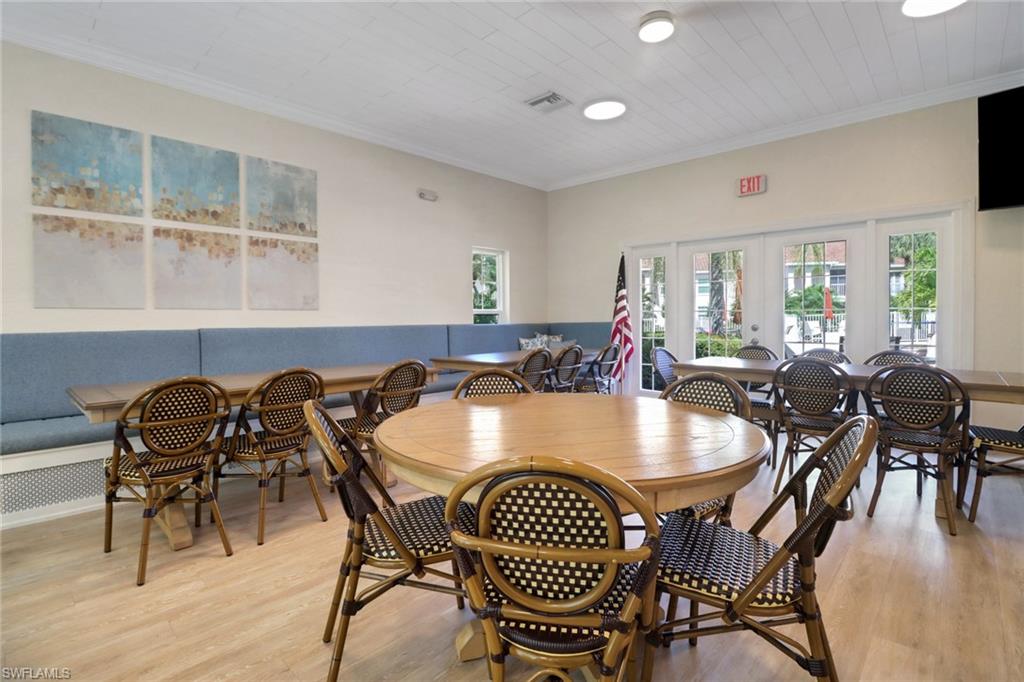110 Siena Way, Unit 206 Naples, FL 34119 - Photo 30 of 35 a view of a dining room with furniture window and wooden floor